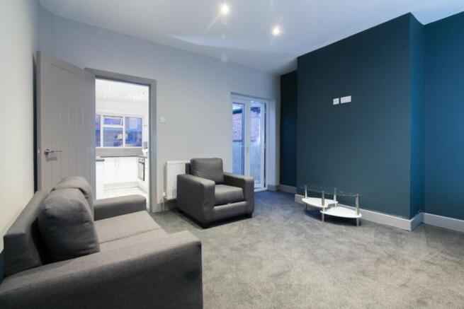 This contemporary living room features a modern...