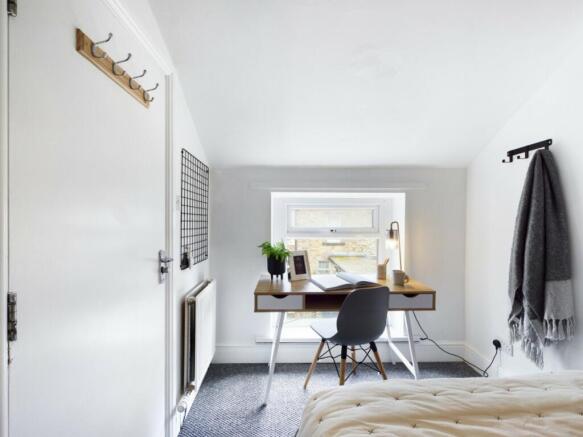 A bright and inviting double bedroom featuring ...