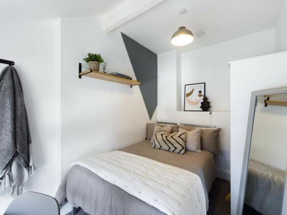 A cozy double bedroom featuring stylish decor, ...