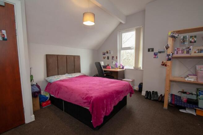 Cozy double bedroom featuring a comfortable bed...