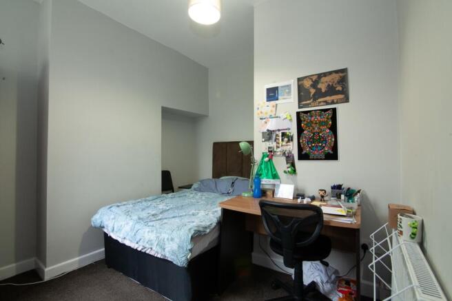 Cozy double bedroom featuring a comfortable bed...