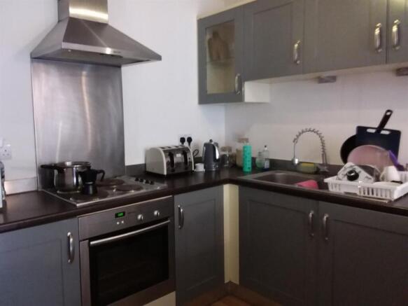 Modern fitted kitchen with stainless-steel appl...
