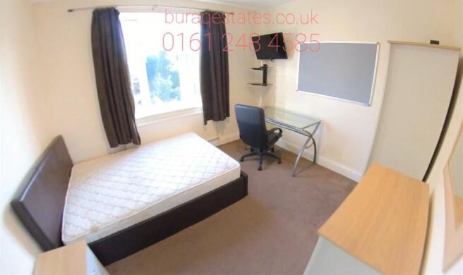 A cozy single bedroom featuring a single bed, a...