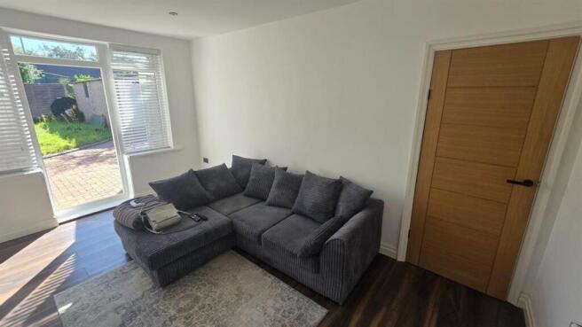A spacious and welcoming living room filled wit...