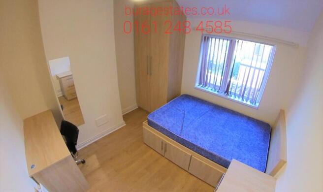 Bright and clean bedroom featuring a spacious d...