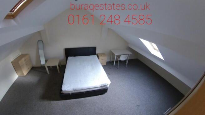 A spacious and tidy master bedroom featuring a ...