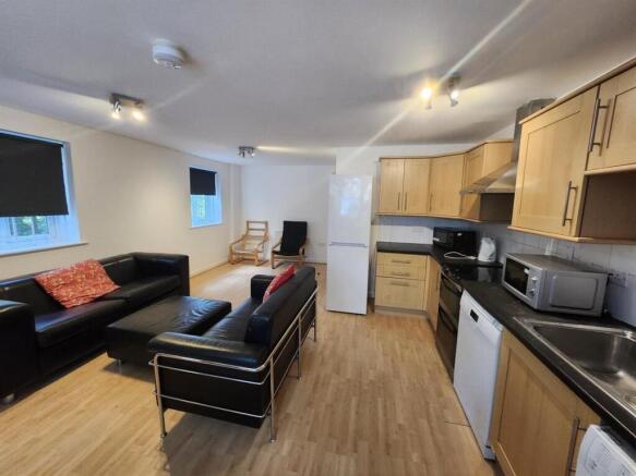 Bright open-plan living area with comfortable s...