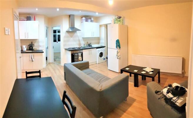 A spacious and bright living room featuring con...