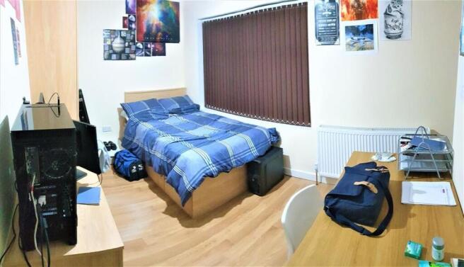 A cozy and well-maintained bedroom featuring a ...