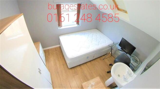 A well-maintained bedroom with a single bed, wa...