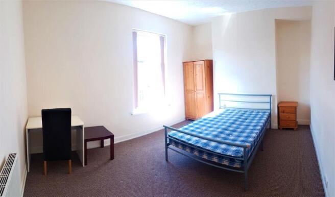 A bright and welcoming double bedroom featuring...