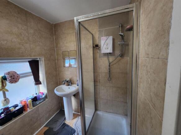 A well-maintained bathroom featuring a shower w...