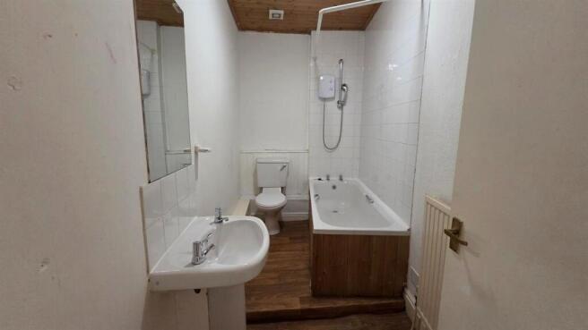 A clean, well-maintained bathroom with a bathtu...