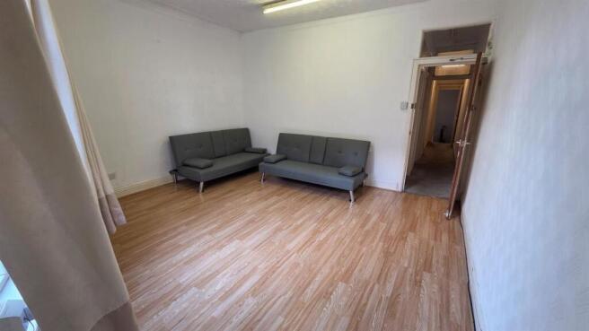 A spacious and well-lit contemporary living roo...