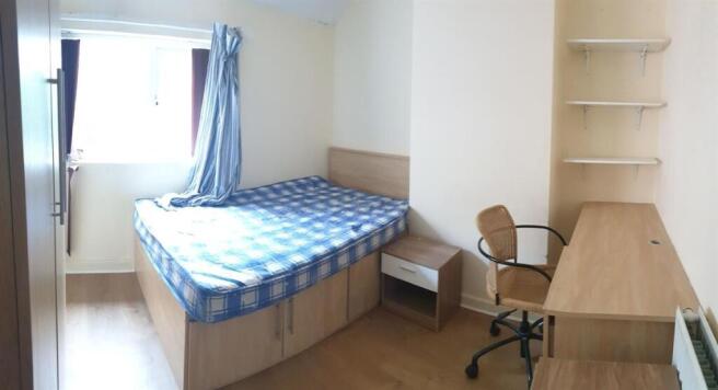 A modest single bedroom with a window bringing ...