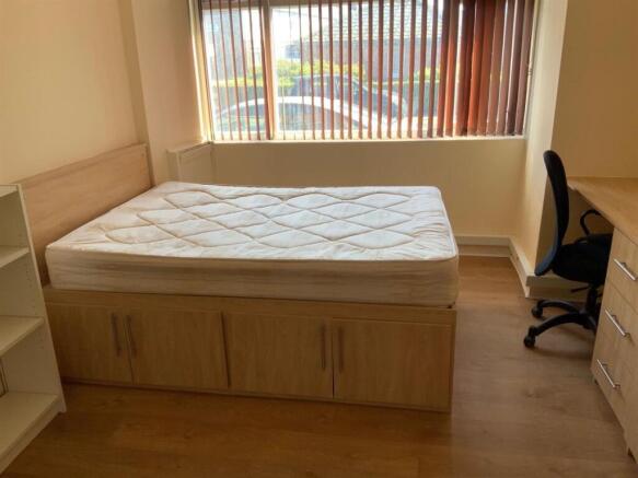 A spacious and bright master bedroom featuring ...