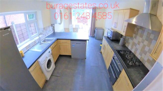 Bright and modern kitchen featuring ample natur...