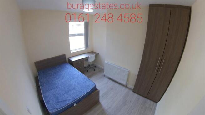 A well-lit, clean double bedroom featuring a co...