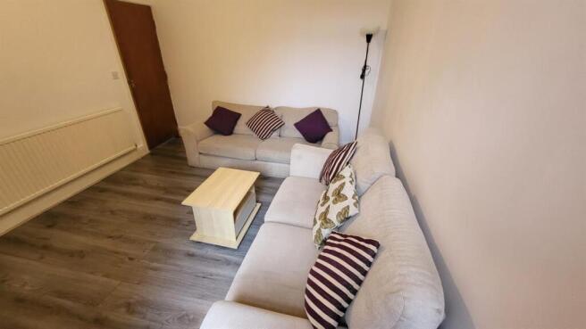 A bright, well-maintained living room featuring...