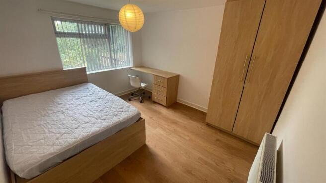 A spacious and well-maintained master bedroom f...