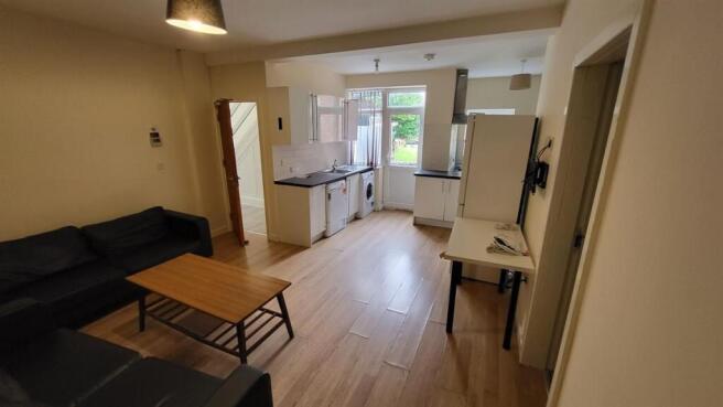 A spacious and well-lit living room with modern...