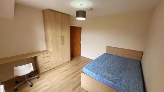 A well-maintained bedroom featuring a comfortab...