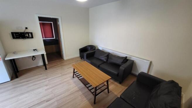 A spacious and well-lit contemporary living roo...