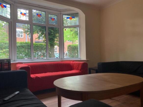 A cozy living room with a large window allowing...