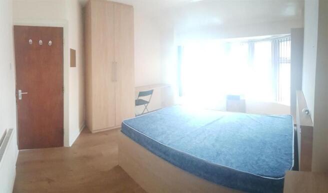 A spacious and well-lit master bedroom featurin...