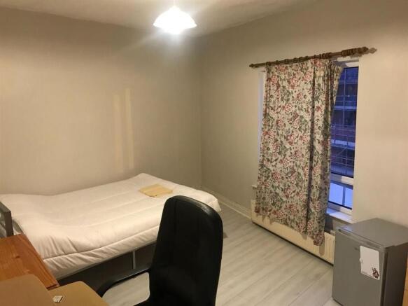 A tidy and inviting bedroom featuring a comfort...