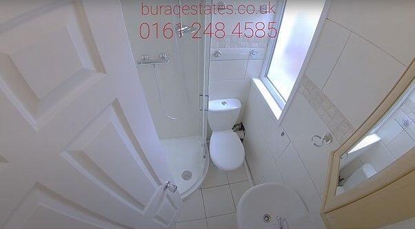 A bright and clean bathroom featuring a shower ...