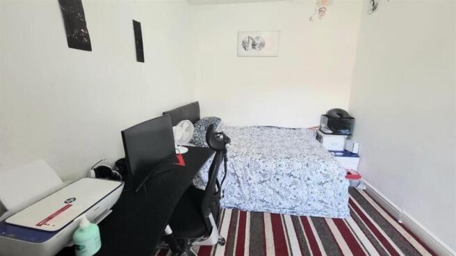 A cozy bedroom featuring a single bed with a fi...