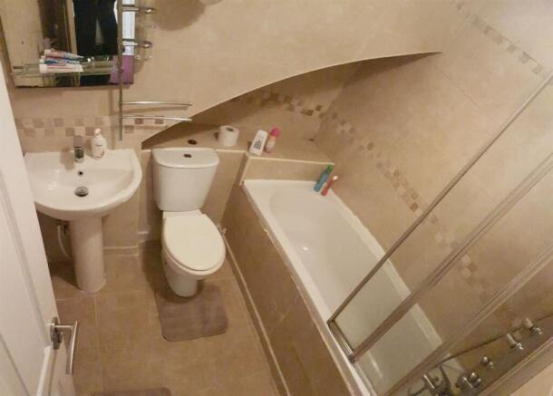 A modern and clean bathroom featuring a bathtub...