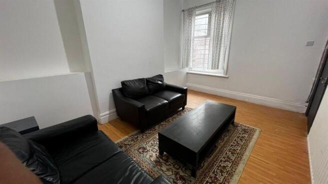 A cozy living room featuring two black leather ...