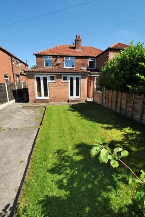 A well-maintained garden with a lush green lawn...