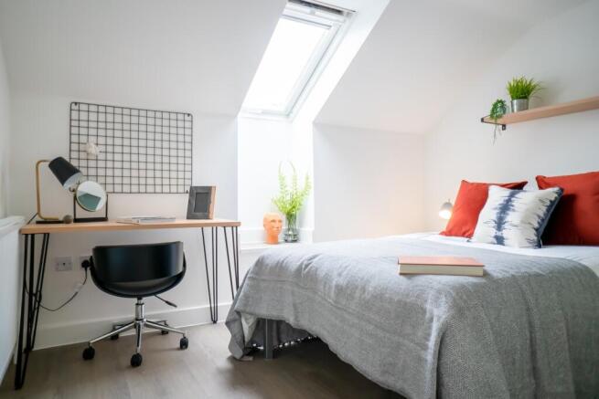 Bright and inviting double bedroom featuring a ...