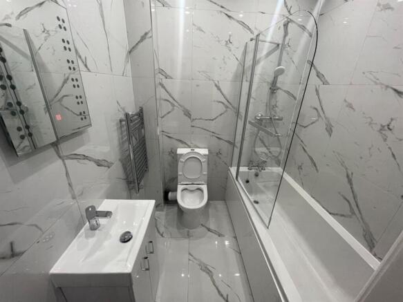 A modern and sleek bathroom featuring a large s...