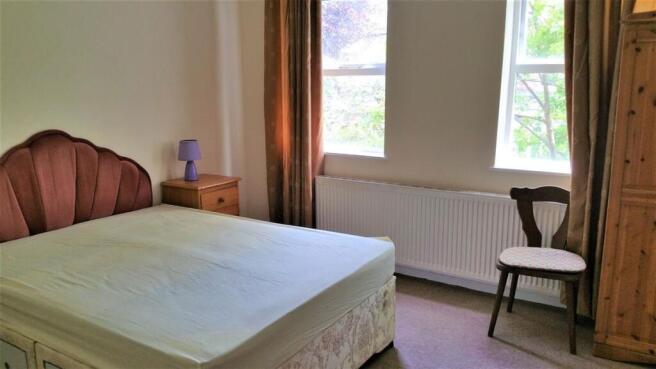 Bright double bedroom with a comfy-looking bed,...