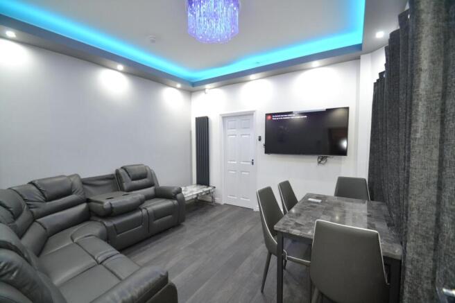 Modern lounge with plush grey leather seating, ...