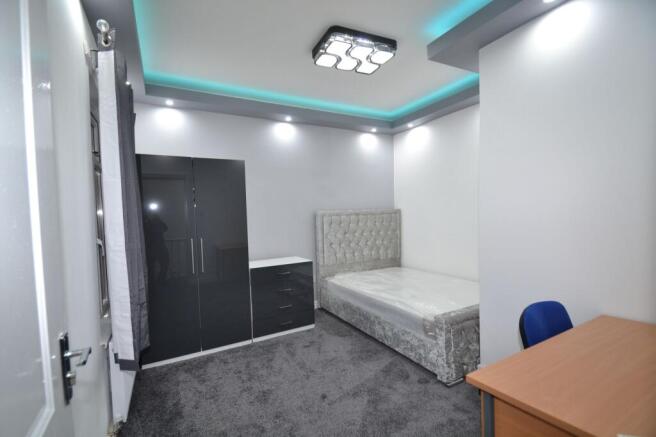 Bright, modern double bedroom with a plush upho...