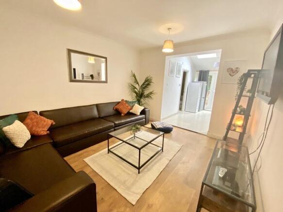 Bright, modern living room with a large L-shape...