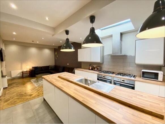 Bright open-plan living area with a modern fitt...