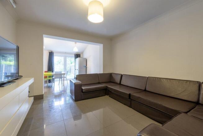 Bright, modern living room with a large L-shape...