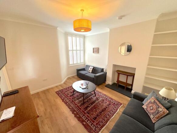 Bright, neatly presented living room with comfo...