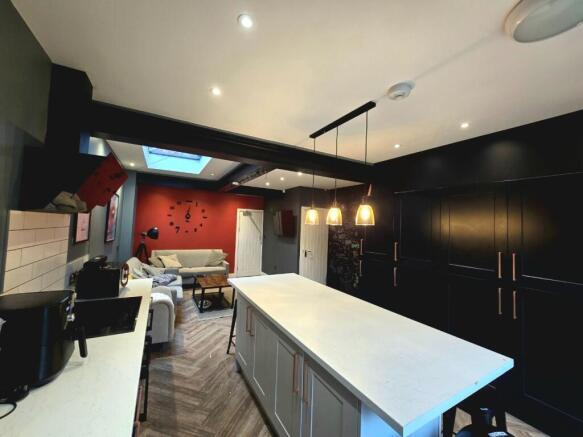 Modern and spacious kitchen featuring a large c...