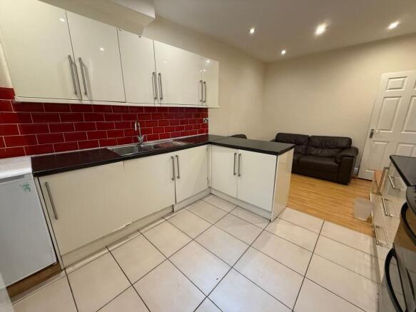 Bright modern kitchen with glossy white cabinet...