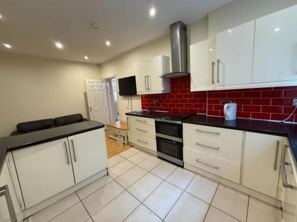 Bright modern kitchen with glossy white cabinet...