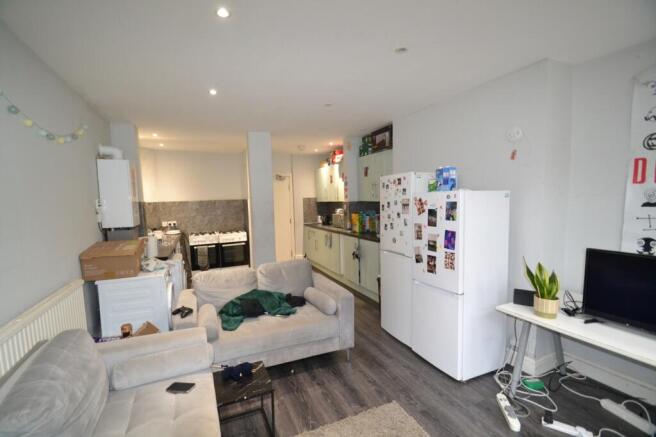 A spacious living room featuring a comfortable ...