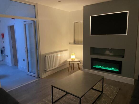 Contemporary living room with a modern inset el...