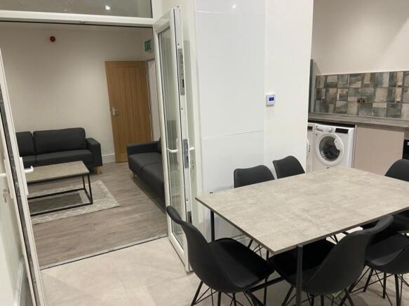 Modern communal lounge with a dining table and ...